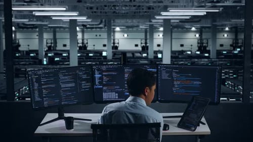 Back View Of Asian Man Developer Working With Tablet While Write Code In Data Center