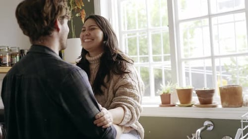 Loving Couple Embracing in Sunny Kitchen