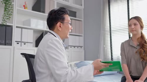 Asian young woman visit and consult health problem with doctor in hospital.