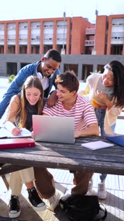 Students Study Together Outdoors at a Wooden Table