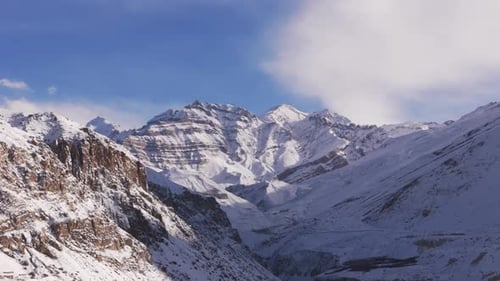 Aerial view of snow-covered mountains and valleys