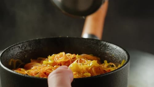Broth Being Poured Over Asian Noodles