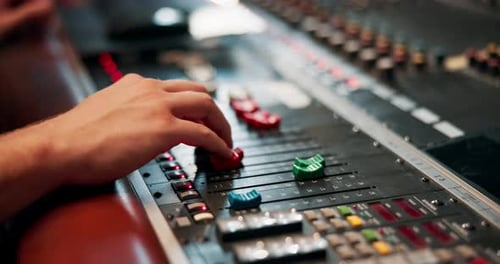 Studio, hand and engineer with music equipment for volume level, frequency mode and control