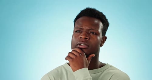 Thinking, confused and black man with solution, questions and doubt with decision on a blue studio