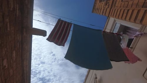 Towels Dry on the Street in the Old Town Between Houses on Narrow Streets