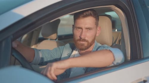 Bearded Man Smiling Inside of Car