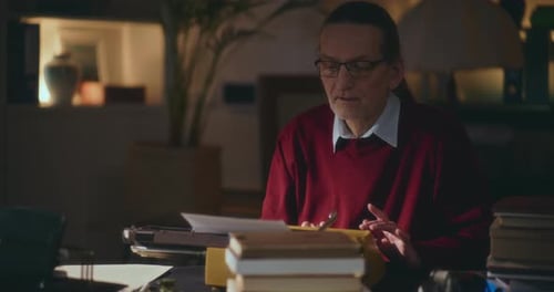 Man Typing on Vintage Typewriter at Desk