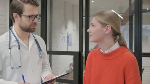 Doctor Talking with Woman in Clinic