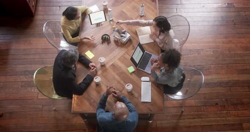 Overhead View on Business People in Meeting with Technology at Creative Office