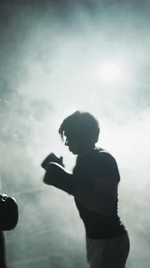 Silhouette of Professional Boxer Training in Gym at Night Future Champion Practicing Punches Active