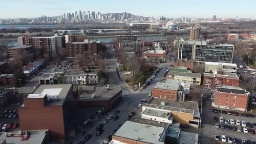 Saint Lambert, Quebec canada aerial footage with Montreal cityscape city skyline at distance clear s