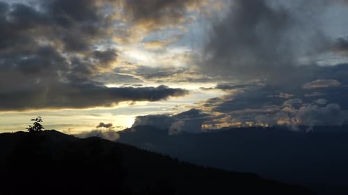 Majestic Mountain Range at Sunrise with Dramatic Clouds