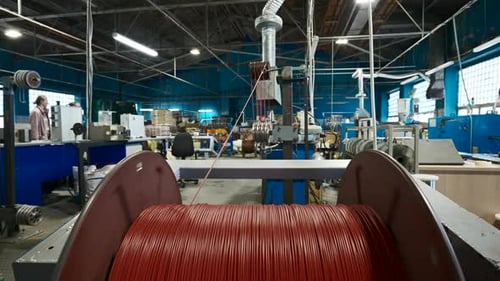 Spinning coil with copper cable close-up. Creative. Industrial background with a workshop.