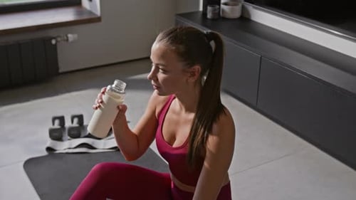 Young Woman Drinks a Protein Shake After Workout