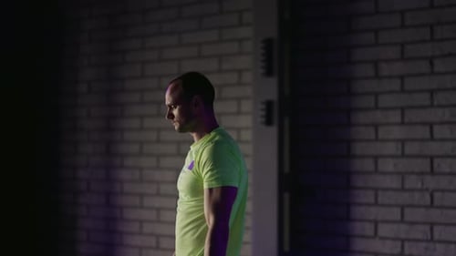 Athletic Man Warming Up Before a Workout in a Gym