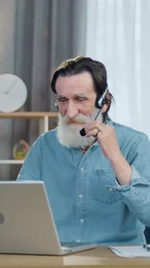 Senior Man Video Call From Home Using Laptop