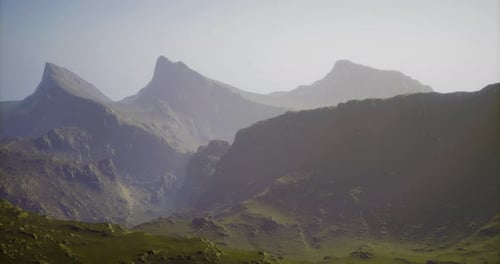 Majestic Mountain Range Towering Under a Clear Sky Illuminates the Landscape