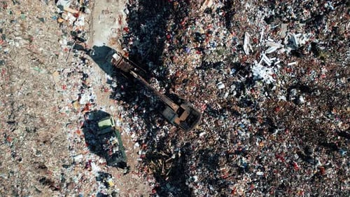 Large Waste Dump and Trash Truck with Garbage in Aerial Top View