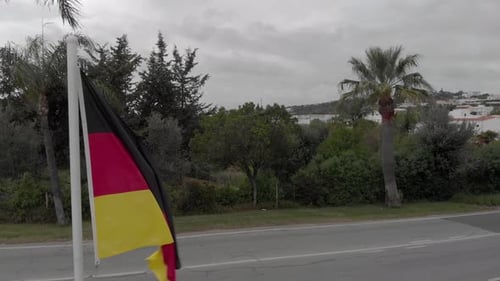 German Flag Waving in the Wind on Cloudy Day