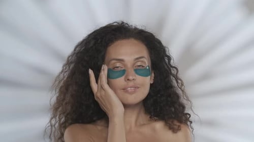 A Woman Performs a Cosmetic Procedure and Demonstrates Smooth Clear Facial Skin Portrait of a