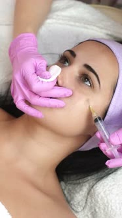 Woman Receives Injection Near Eye at Medical Clinic