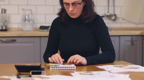 Woman At Home Counting Finances
