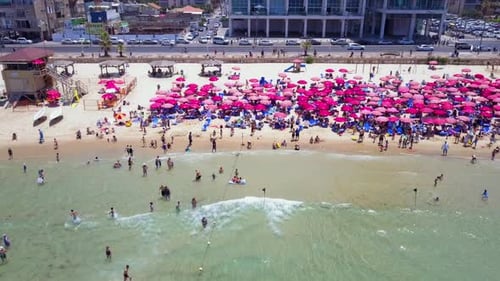 Mediterranean beach during summer with people in the water
