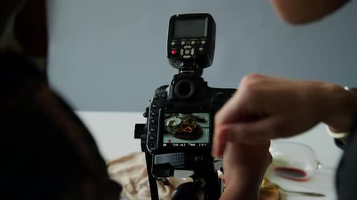 Photographer and Stylist Taking Food Pictures in Studio