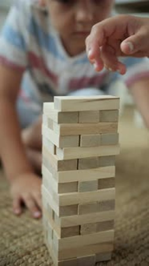 Kids Playing Jenga Close Up Kids Building a Figure Out of Bricks