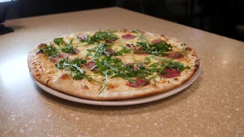 F33. Serving the finished pizza to the table. Ready pizza dish