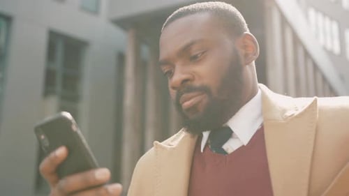 Close Up Face Serious African American Young Attractive Man Use Phone Standing on Street Sunlight