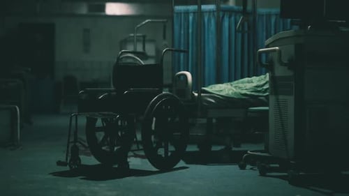 Empty Hospital Room with Wheelchair and Patient Bed During Nighttime Hours