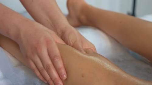 Masseuse Massages Thigh and Legs Close Up Anticellulite Massage in Spa Salon Relaxing Treatment