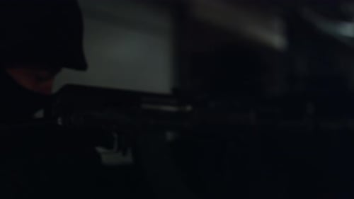 Men Hold Assault Weapons in Dark Urban Environment