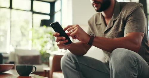 Man Using a Mobile Phone in a Home Setting