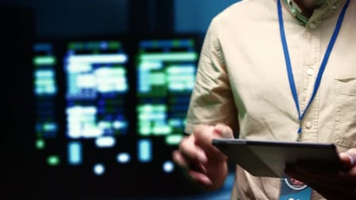Man Uses Tablet in Data Center, Close Up