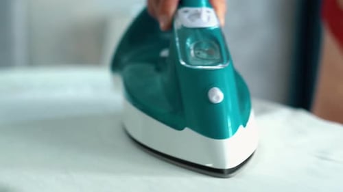 Caucasian Girl is Wearing Red Sexy Underwear and Gently Ironing Clothes Green Iron is Ironing White