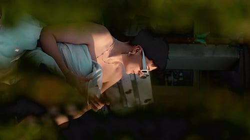 Young Adult Relaxing in Bed at Home