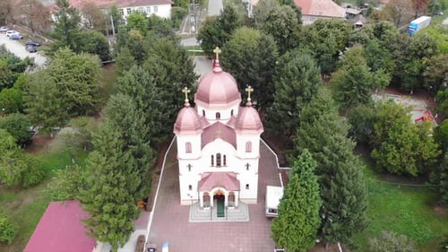 Drone Aerial over orthodox church in Romania sunny countryside