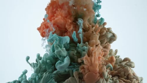 Swirling Blue and Orange Ink Droplets on White