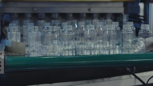 Plastic Bottles Move on the Conveyor Plastic Blanks Advance Along the Linear Conveyor