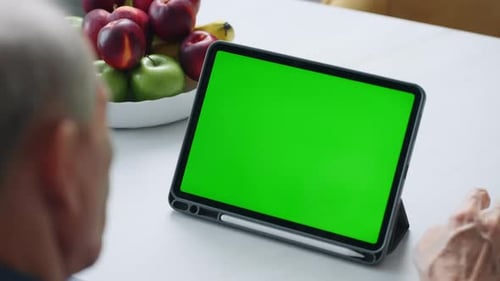 Communication By Video Call In Tablet Gadget With Chroma Key Green Screen Mature Man Use Internet