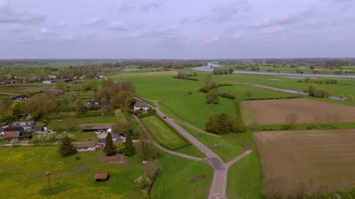Aerial View: Countryside Road along the IJssel River Dike in Netherlands