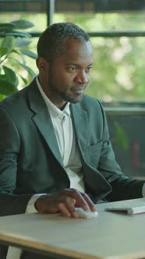 A Dedicated Professional Businessman is Diligently Working at His Modern Office Desk Today