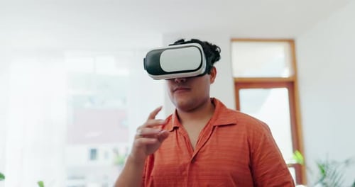 Young Adult Interacting with VR Headset at Home