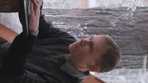 Young Adult Using Tablet Device in Winter