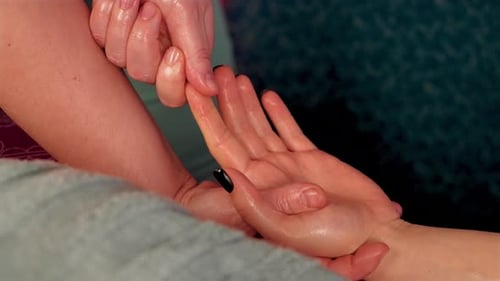 Close Up Hands of Female Masseur Doing Finger and Palm Massage to Unrecognizable Woman Lying on
