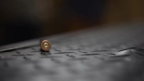 Bullet Shell Casing Falling on Metal Surface
