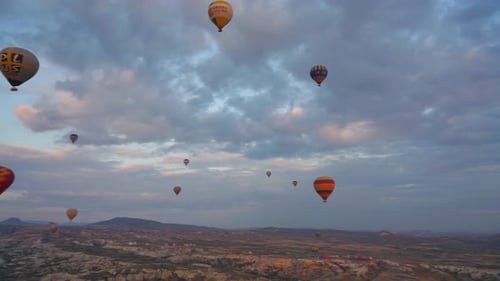 Many Hot air balloons flying over Cappadocia, Turkey, during a bright cloudy sunrise. Turkish Balloo