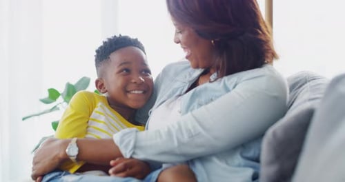Loving Mother Embracing Son at Home Smiling